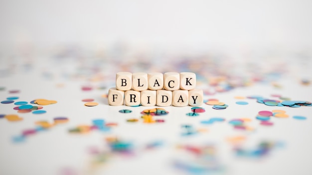 Free photo black friday inscription on small white cubes with confetti