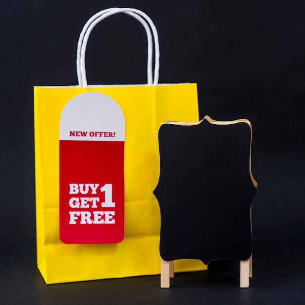 Free Photo black friday sales concept with bag and board