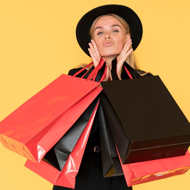 Black friday shopping woman blowing kiss gesture