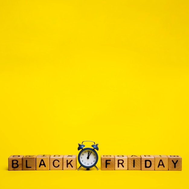 Black friday word on yellow background with copy space