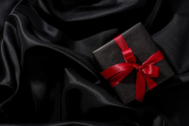 Black gift box with red bow