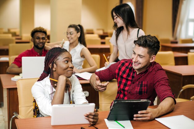 Black girl talking to classmate in library