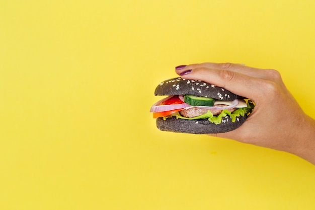 Free photo black hamburger with copy space