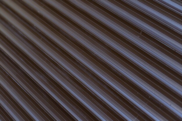 Black iron tin fence lined background. Metal texture