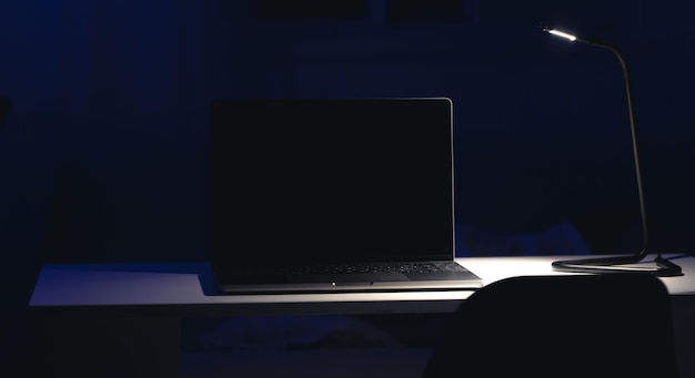 Free photo black laptop screen in a dark room at night