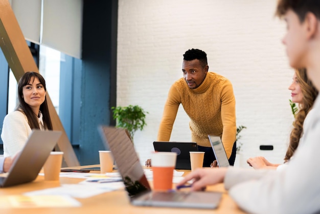 Free photo black male team leader at business meeting in an office