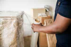 Free photo black man moving furniture