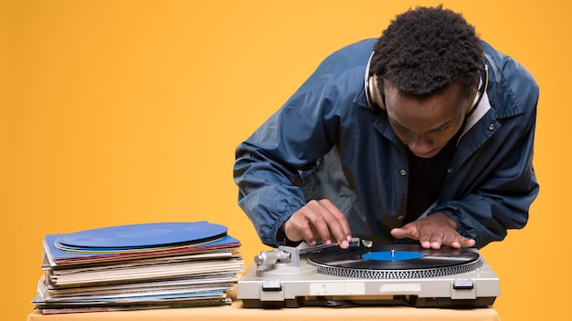 Black man posing with vinyls