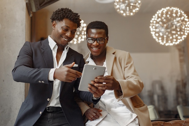 Black men in a cafe have a business