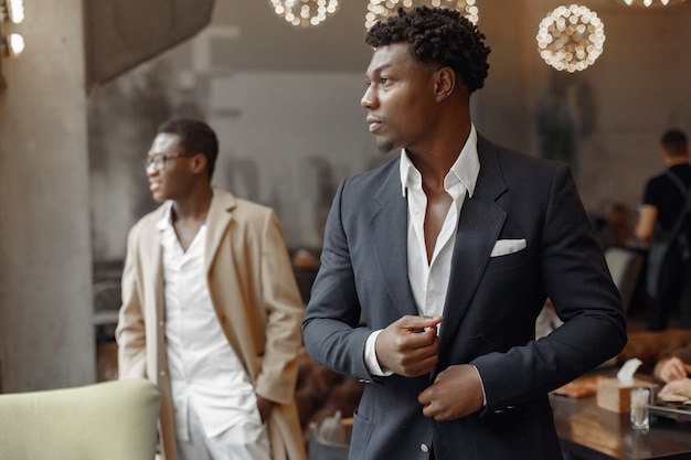 Free photo black men in a cafe have a business