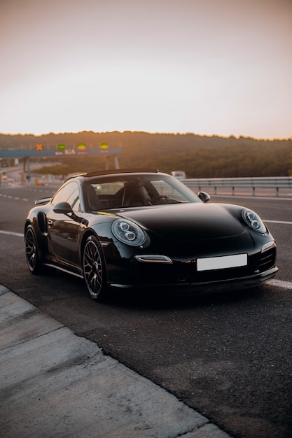 Black mini coupe on the road.