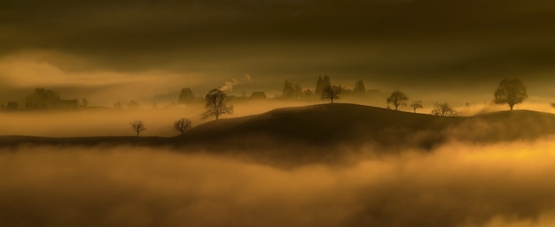 Free Photo black mountain surround in fog