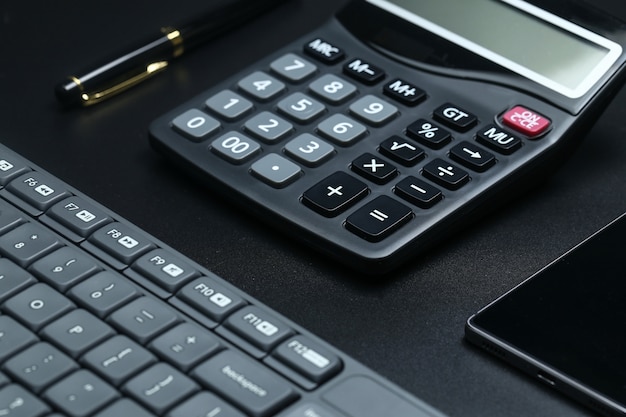 black office business equipment on black background