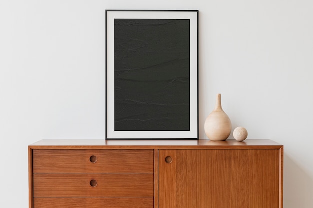 Black picture frame on wooden cabinet