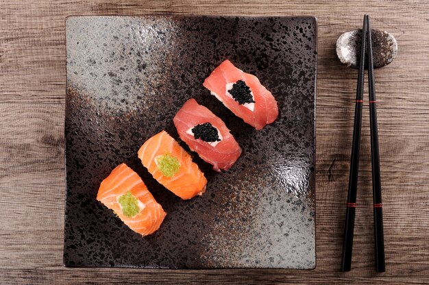 Free Photo black plate with sushi assortment