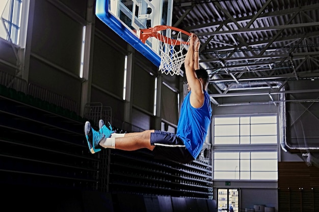 Black professional basketball player in action on a basketball field.