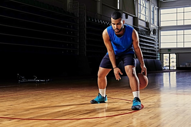 Black professional basketball player in action on a basketball field.