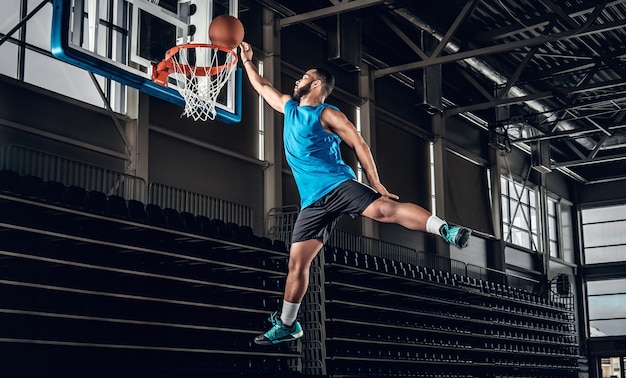 Black professional Black basketball player in action in a basketball court.