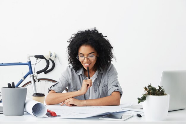 Black school or college student finishing home task, correcting mistakes in her drawings