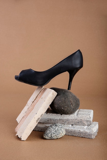 Black shoe on rock in studio