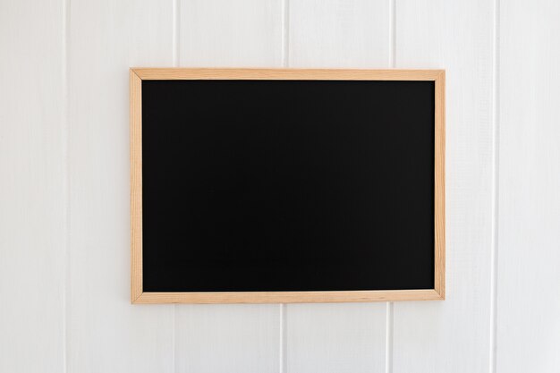 Black slate on white wooden background