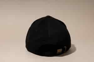 Free photo black stylish cap on a light background