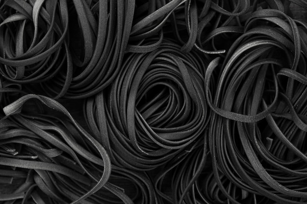 Free photo black tagliatelle pasta