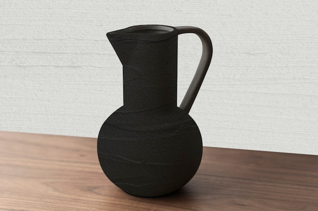 Free photo black textured ceramic jug vase on a wooden table