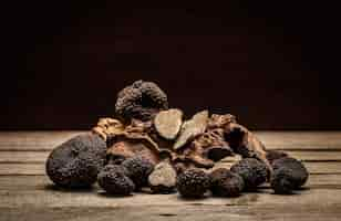 Free photo black truffles mushrooms on rustic wooden table with free text space