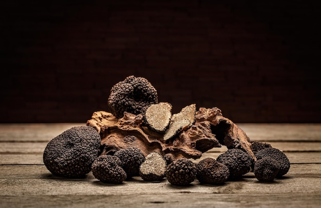 Free Photo black truffles mushrooms on rustic wooden table with free text space