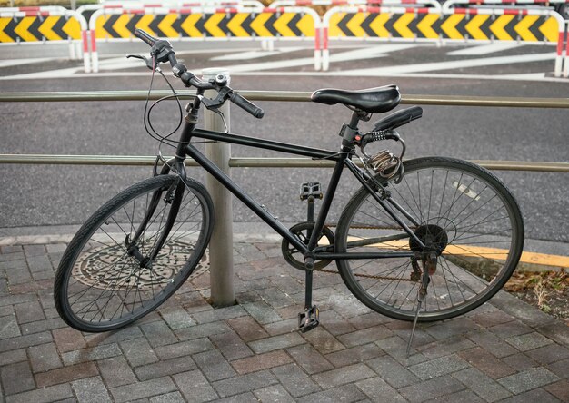 Black vintage bicycle parked on alley