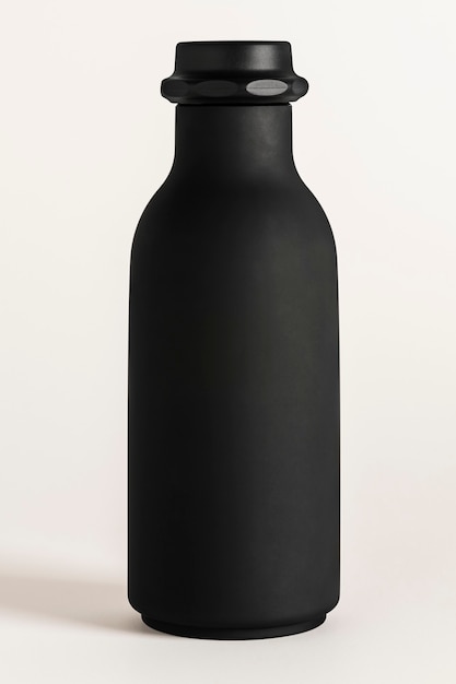 Black water bottle mockup on an off white background