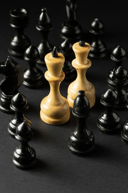 Free Photo black and white chess pieces on black background