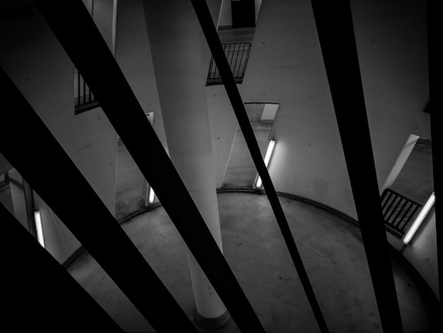 Black and white photo of circular room with pillar in center