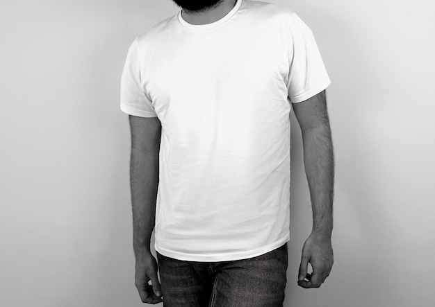 Black and white photo of man wearing a white tshirt on white background