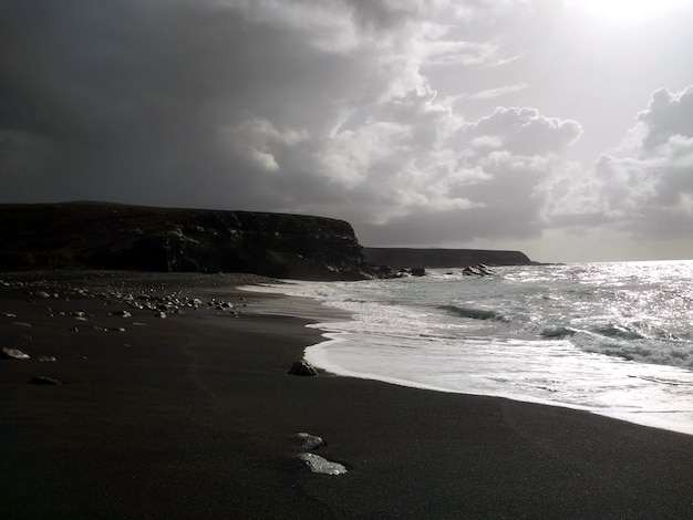 Black and white picture of calm waves on the coastline