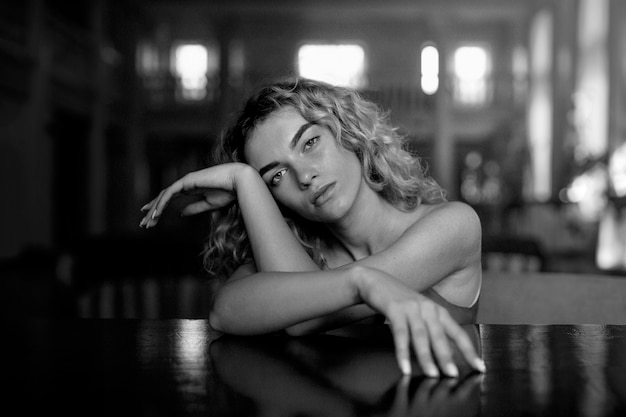 Black and white portrait of beautiful woman posing artistically indoors