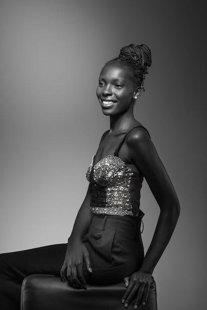 Black and white portrait of woman on chair in old hollywood glamour style