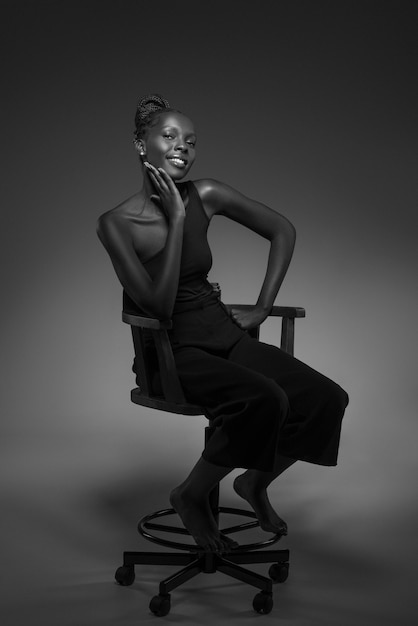 Free Photo black and white portrait of woman on chair in old hollywood glamour style