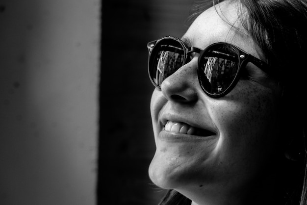 Black and white portrait of woman wearing sunglasses