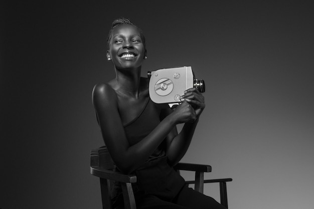 Black and white portrait of woman with camera in old hollywood glamour style