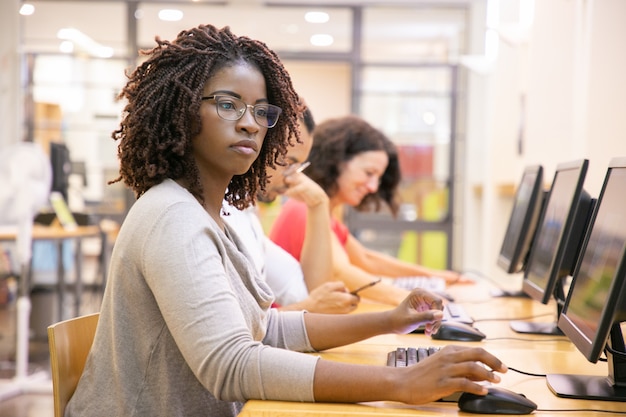 Black woman adult student working in computer class