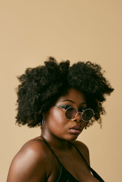 Black woman posing in studio side view