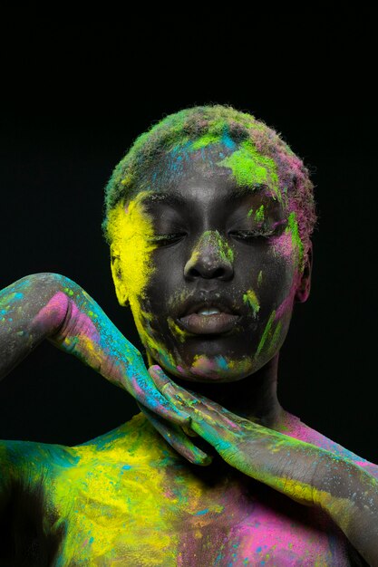 Black woman posing with colorful powder