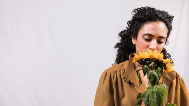 Black woman smelling flower