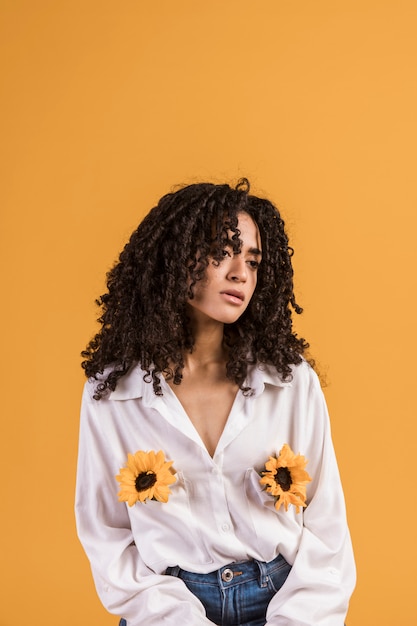 Free photo black woman with flowers in shirt pockets