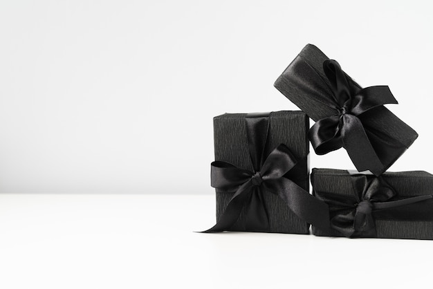 Black wrapped gifts on plain background