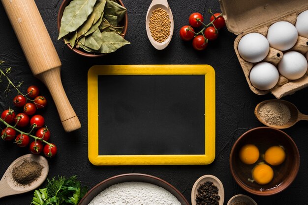 Blackboard amidst cooking ingredients