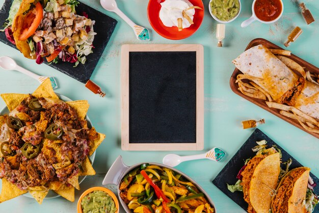 Blackboard amidst Mexican food on blue background