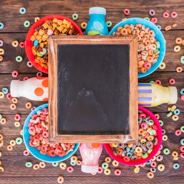 Free photo blackboard on bright bowls of cereals and bottles